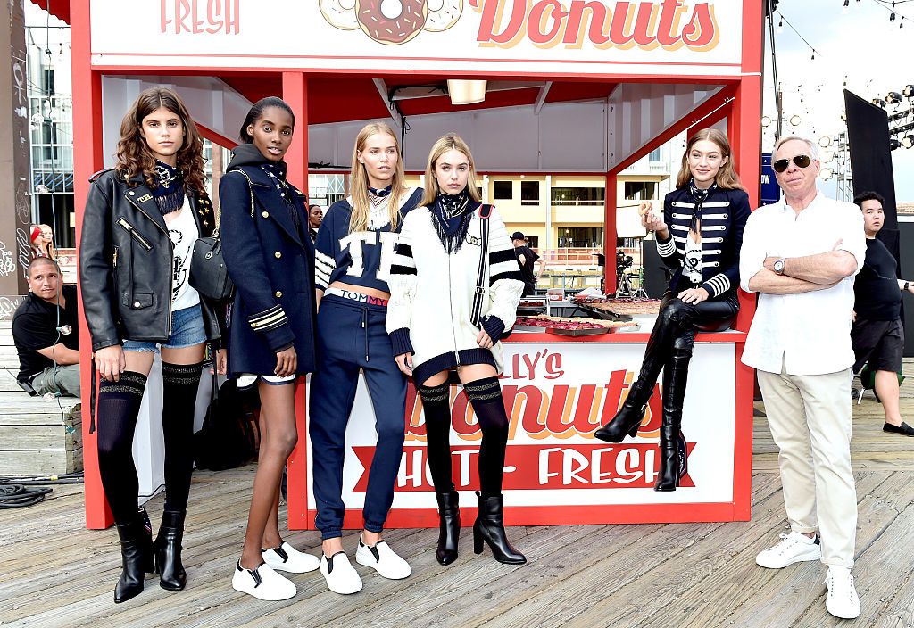 Tommy Hilfiger with Gigi Hadid (seated), who has her own Tommy "collaboration" line, and other models<br>